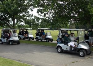 golf carts on a path at the tournament