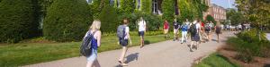 students walking in front of iconic Alumni Hall