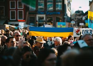ukranian flag is held above a crowd of people