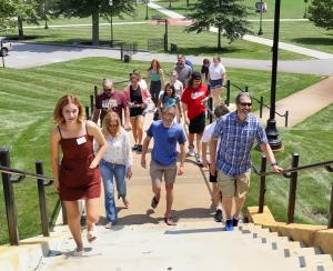 leaders and families walking up courtyard stairs