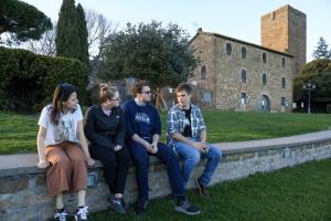 Student sit on a wall talking