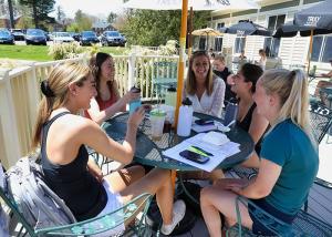 Student enjoy a meal on the C-Shop patio