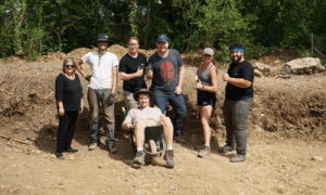 Students pose for a picture at the dig site