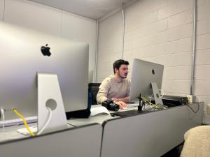 Student working on a project on an iMac