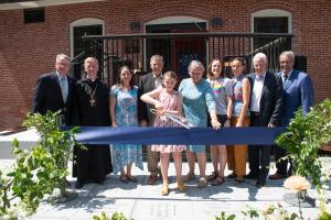 Briar Grappone, 10, cuts the ribbon at the dedication and blessing of the Gregory J. Grappone Humanities Institute.