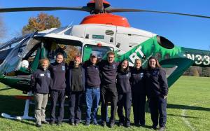 EMS team posing in front of a medical helicopter