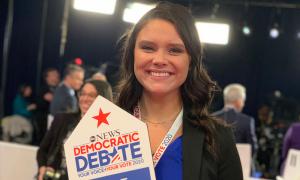 Saint Anselm student holding Biden sign in the spin room