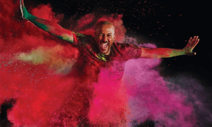 Aaron Tolson dancing in a cloud of colored smoke