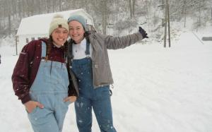 Two students standing in the snow