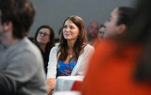 Candid photo of a young woman sitting at a table