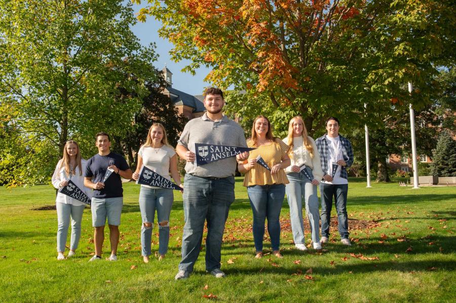 Saint Anselm students standing on the quad with mini class banners