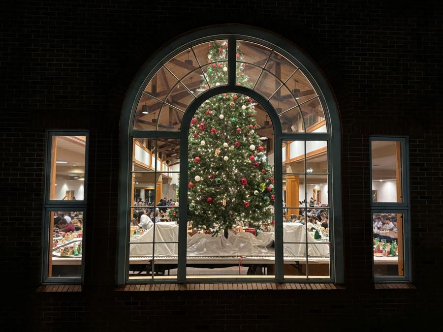 View of a christmas tree through the window of a dining hall