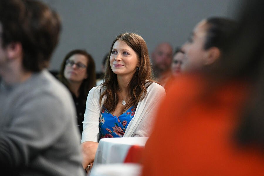 Candid photo of a young woman sitting at a table
